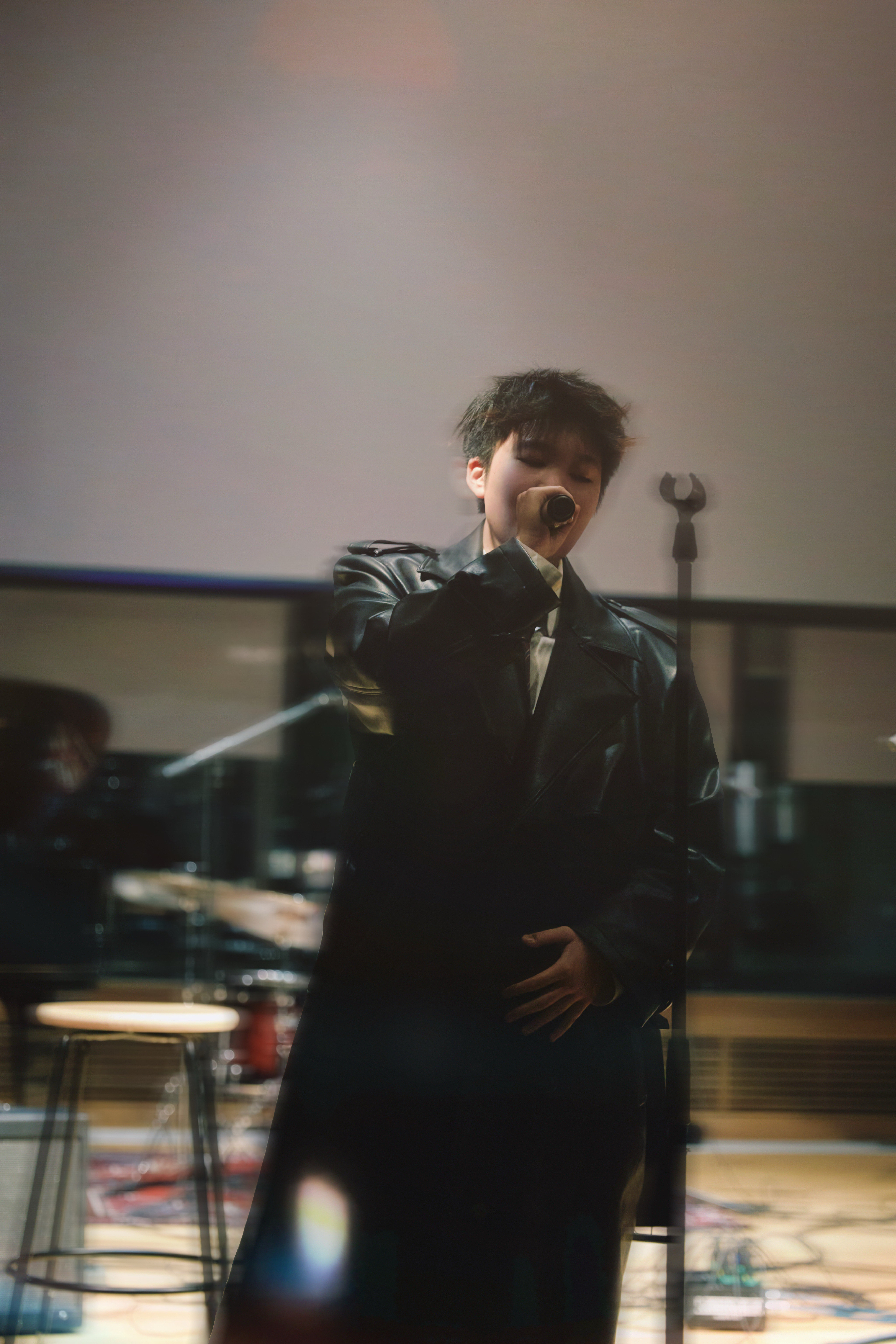 Jen Zou performing in leather coat