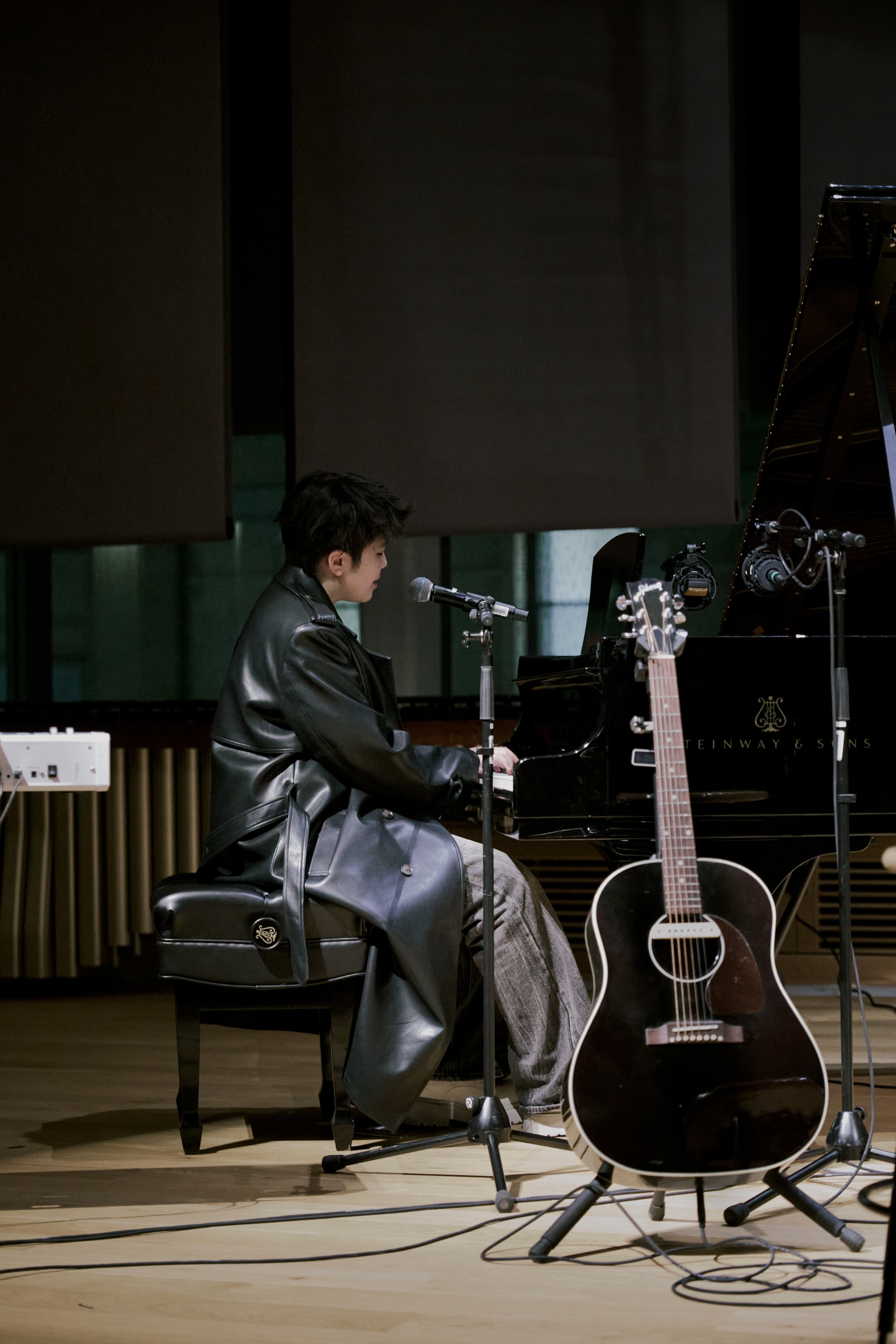 Jen Zou on stage with blue lighting