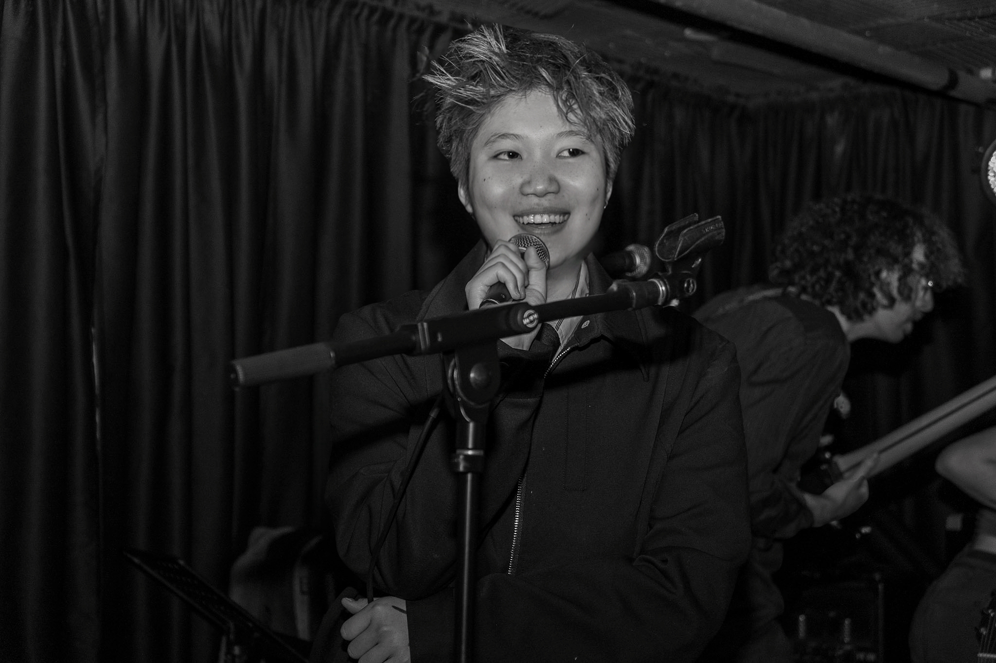 Jen Zou singing in black and white