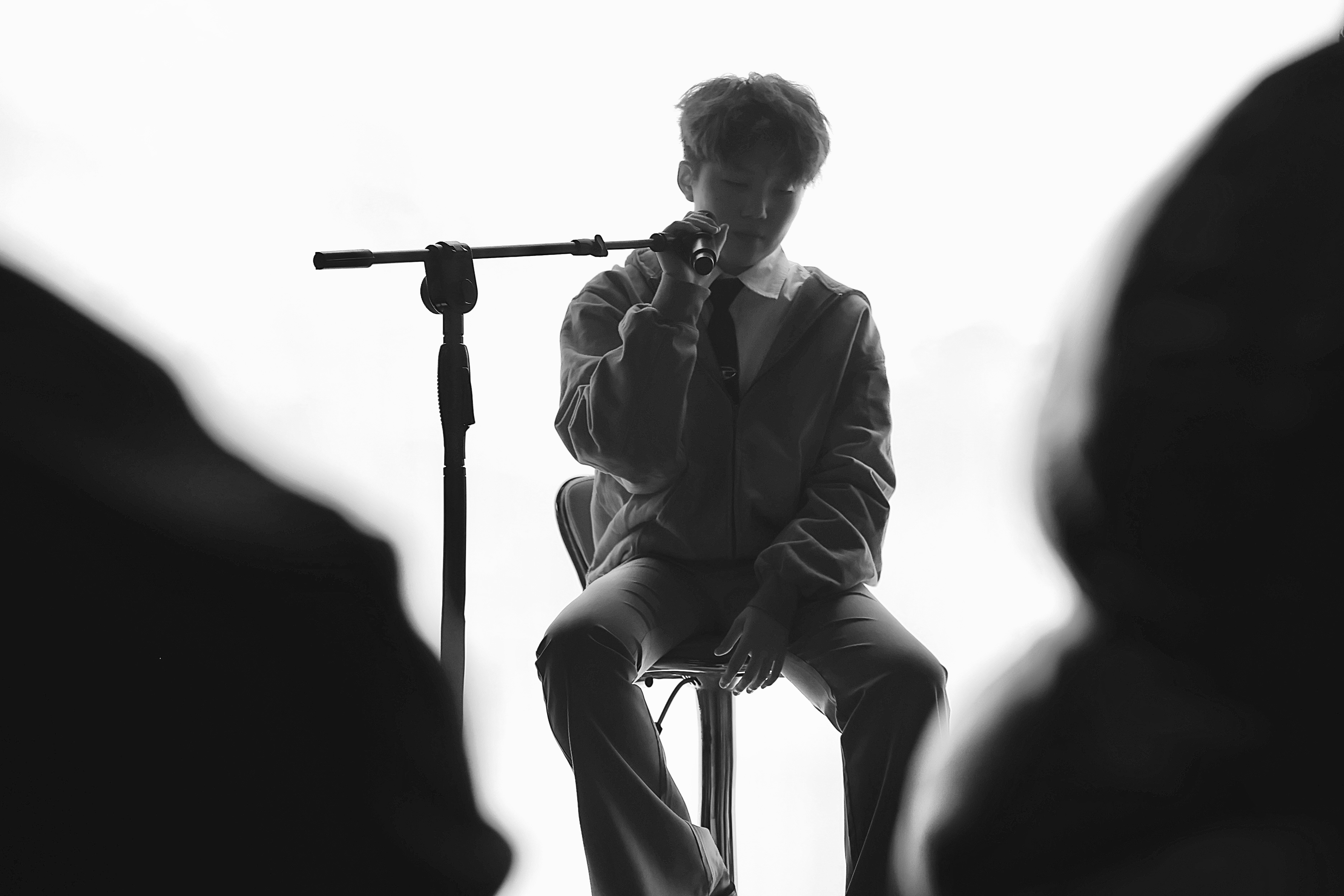 Jen Zou on stool with microphone